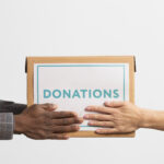 volunteer-giving-box-with-donations-another-volunteer
